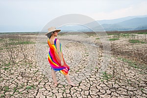 Woman portrait in dryland with drought ground texture. concept climate changed.