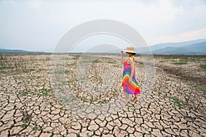 Woman portrait in dryland with drought ground texture. concept climate changed.