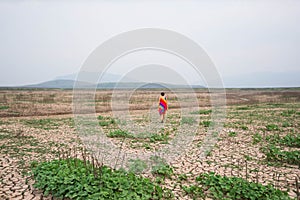 Woman portrait in dryland with drought ground texture. concept climate changed.