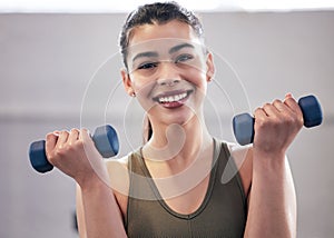 Woman, portrait and dumbbell in gym for power, exercise and training for strong arm muscle. Person, challenge and