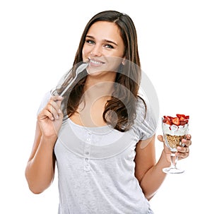 Woman, portrait and eating dessert food in studio with strawberry fruit and yogurt for breakfast or healthy snack. Face