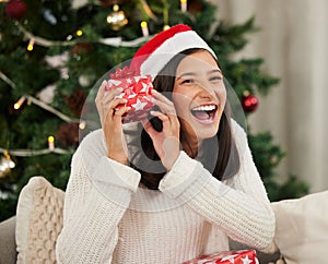 Woman, portrait and excited with Christmas present for holiday giveaway, home or happiness Female person, face and hat