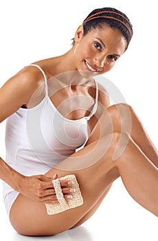 Woman, portrait and exfoliate legs for beauty, white background and aesthetic wellness. Body care, exfoliation and