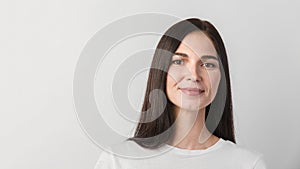 Woman portrait isolated against white background. Young woman with clean face skin. Self care concept. Woman face closeup