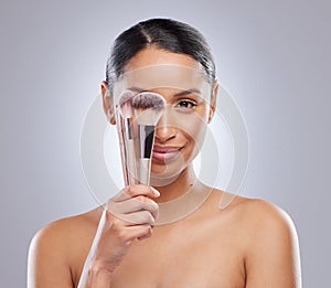 Woman, portrait and makeup beauty or brush for skin care cosmetics as model, grey background or makeover. Female person