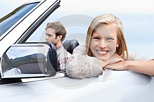 Woman, portrait and man driving convertible for travel adventure for vacation, road trip or holiday. Couple, relax and