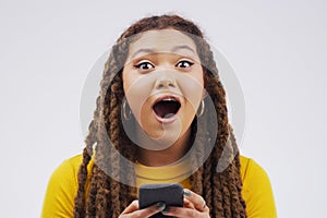 Woman, portrait and phone surprise in studio, victory notification and lottery success. Female person, shock and excited