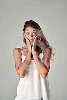 Woman, portrait and shock for gossip in studio, conflict and drama news or info on gray background. Female person