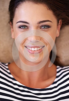 Woman, portrait and smile on floor, above and pride with closeup, relax and home in living room. Girl, person and happy