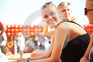 Woman, portrait and smile at music festival with friends for relax at concert, audience crowd or carnival performance