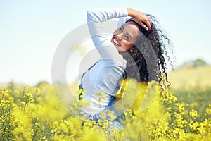 Woman, portrait and smile in nature with flowers for adventure, travel and holiday in countryside. Gen z, female person