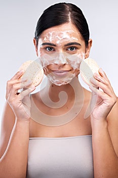 Woman, portrait and sponge in studio, exfoliate and skincare for washing face on white background. Female person photo