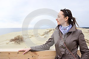 Woman portrait, standing on tongue of sand, looking far away, copyspace