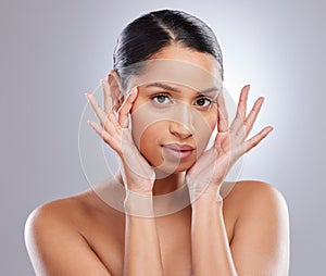 Woman, portrait and studio for beauty and hands, face and skincare on gray background. Dermatology, body care and glow