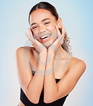 Woman, portrait and studio for beauty and hands, smile and skincare on blue background. Dermatology, body care and glow