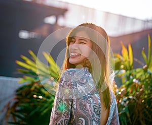 Woman portrait with sunflare on with construction site on the background for developing city woman cocnept photo
