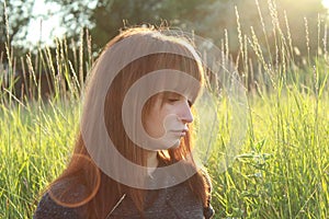 Woman portrait at sunset on the background of nature