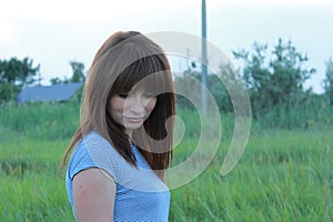 Woman portrait at sunset on the background of nature