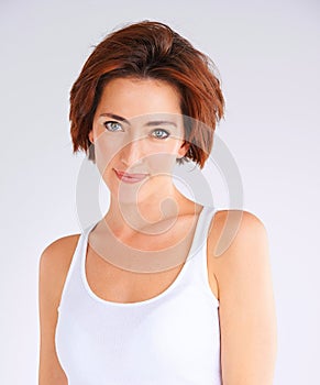 Woman, portrait and tank top for fashion in studio with confidence, attitude and jeans for trendy style. Girl, organic