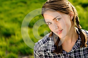 Woman, portrait and wellness in grass field for spring with happiness, flowers and relax. Female gen z person, rest and
