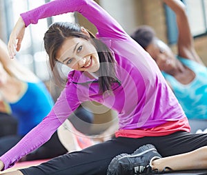 Woman, portrait and yoga class at gym, stretch and yogi instructor for exercise on mat. Female person, trainer and