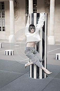 Woman pose on high heel shoes in paris, france. Beauty girl with glamour look. Fashion model in sunglasses on square