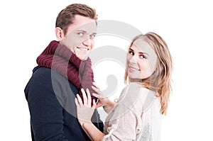 Woman posing and arranging man's autumn casual neckcloth