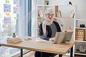 Woman posing behind computer on working day in office