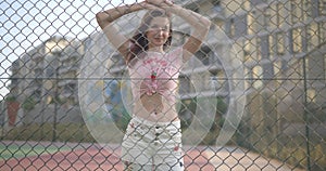 Woman posing behind a netting