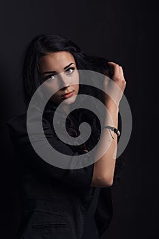 woman posing on a black background