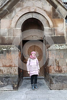 Woman posing on Etchmiadzin Cathedral background