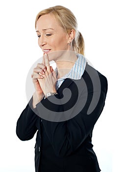 Woman posing with fingers on her lips