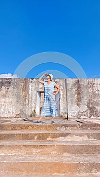 A woman posing in front of an historial old building
