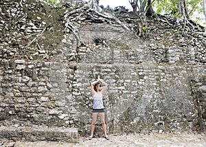 Woman posing in front of a Ruin in the COBA Zona Arqueologica photo