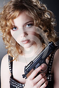 Woman posing with a gun