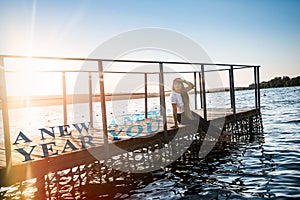 Woman posing on moorage, `New year, new you` concept