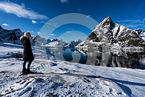 Woman posing in the mountains of the Lofoten Islands. Reine, Norway