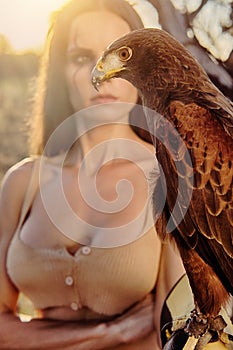 Woman posing on nature with eagle