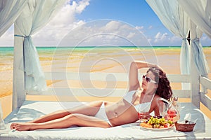 Woman posing outdoors taking sun baths at the sea