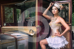 Woman posing over retro car