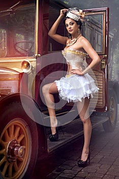 Woman posing over retro car