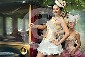 Woman posing over retro car