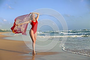 Woman posing with pareo on the beach