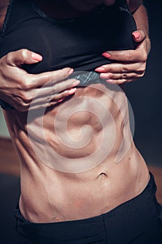 Woman posing with perfect abdomen muscles