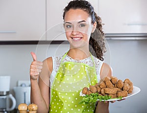 Woman posing with plate of deep-fried kroketten
