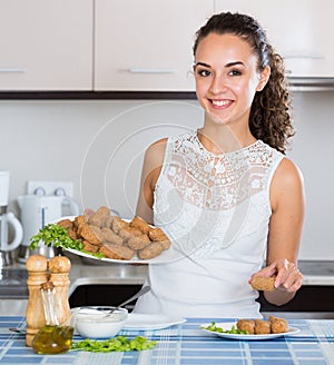 Woman posing with plate of deep-fried kroketten