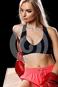 Woman posing in red boxing gloves