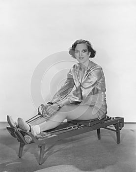 Woman posing on rowing machine