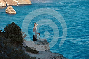 Woman posing on sea rock. Breathtaking summer landscape. Thirst of travel concept. Lifestyle change and travelling idea
