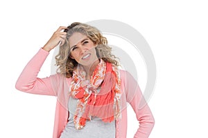 Woman posing and smiling while scratching her head